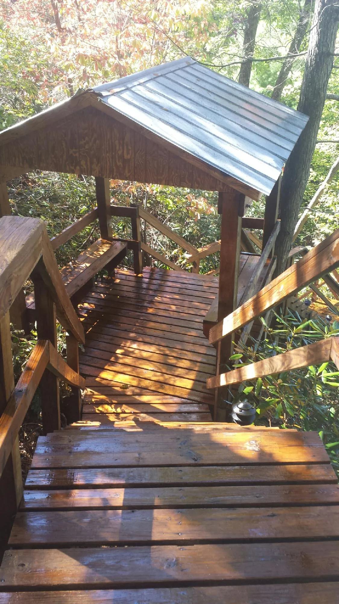 Freshly stained wood walkway and covered shelter with a metal roof in Princeton